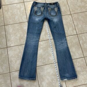 Miss Me jeans, lighter wash.